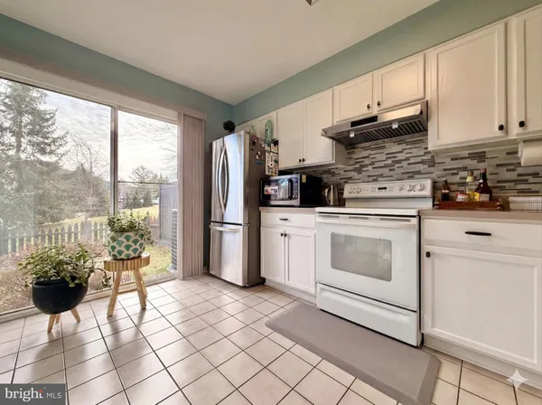 a kitchen with stainless steel appliances a stove a refrigerator sink and cabinets