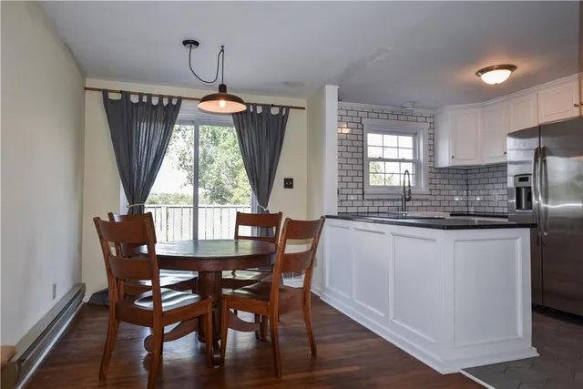a kitchen with stainless steel appliances granite countertop a sink and a refrigerator