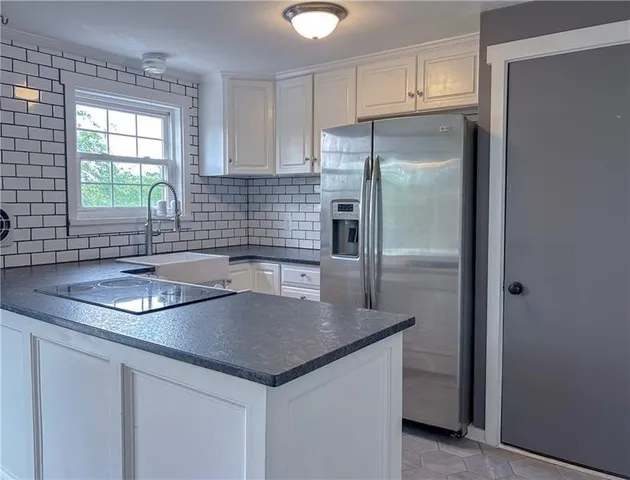 a kitchen with a sink stove and cabinets