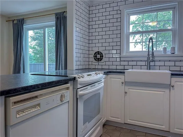 a kitchen with a refrigerator and a stove