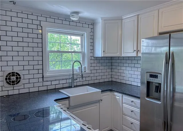 a kitchen with a table chairs and microwave