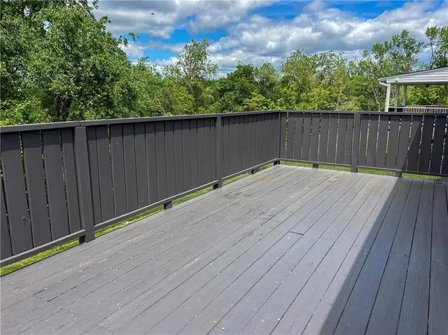 a view of a wooden deck with a yard