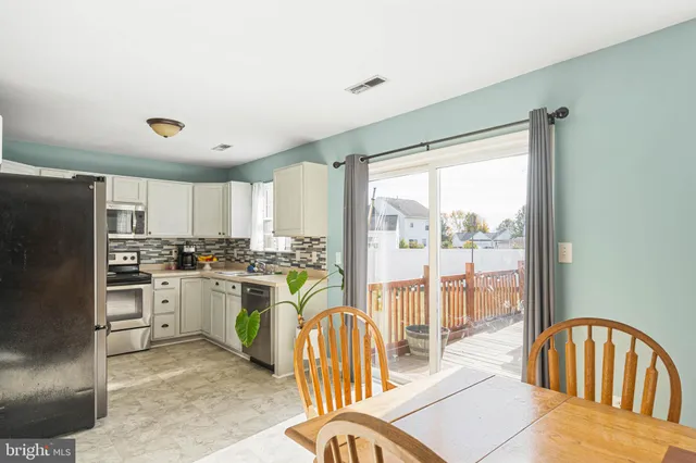 a kitchen with a table chairs stove and refrigerator
