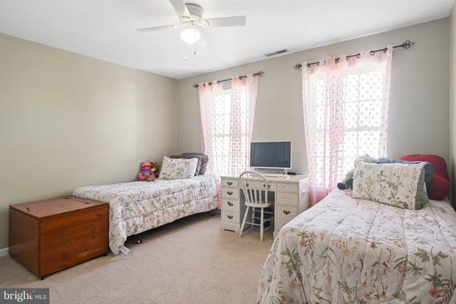 a bedroom with two beds and a couch