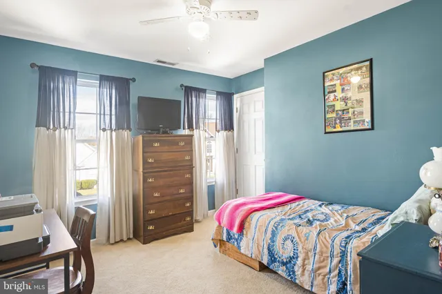 a bedroom with a bed and a tv