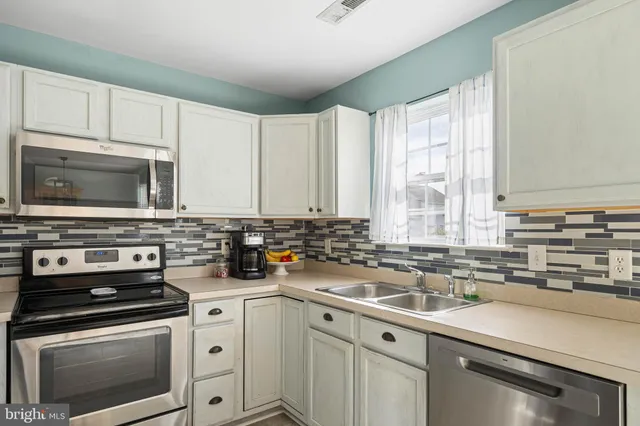 a kitchen with a sink stove and microwave
