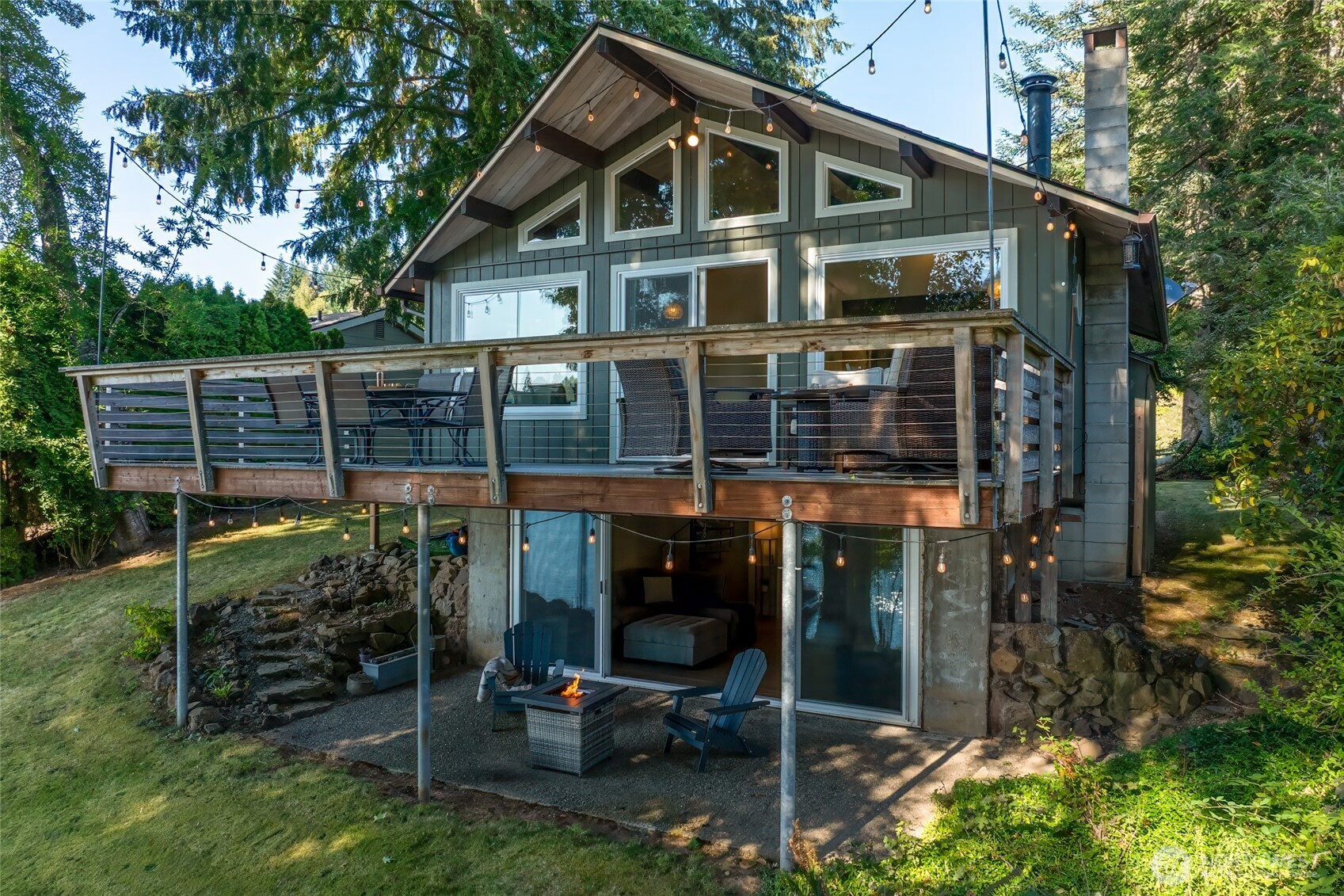 a view of a house with backyard porch and sitting area