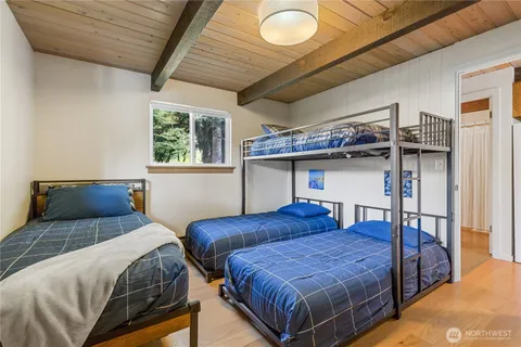 a bedroom with two beds and a dresser