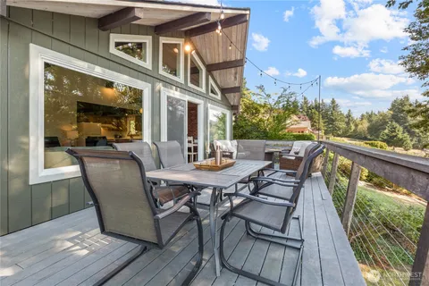 a view of a chairs and table in the balcony