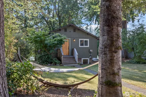a view of a small house with a small yard and plants