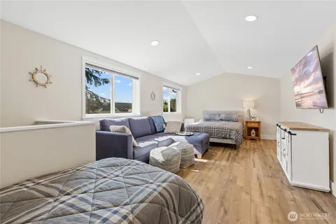 a bed room with two bed and a window