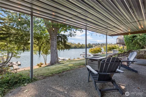 a view of patio with a table chairs and a backyard