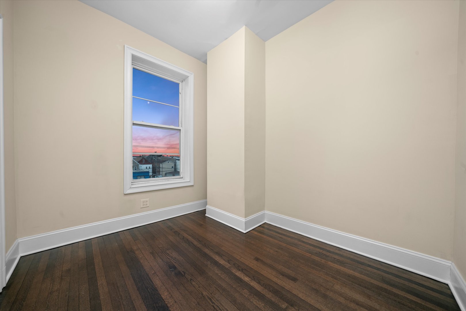 2128 West Cermak Road Chicago, IL 60608 - Photo 6 of 16 a view of an empty room with wooden floor and a window