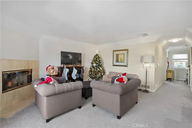 a living room with fireplace furniture and a flat screen tv