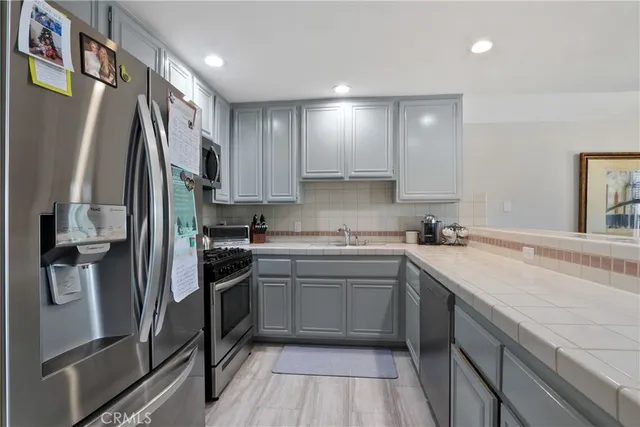 a kitchen with a sink stove and refrigerator