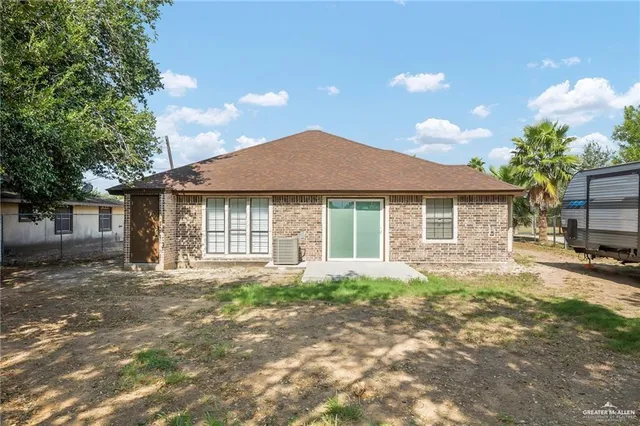 a front view of a house with a garden and yard
