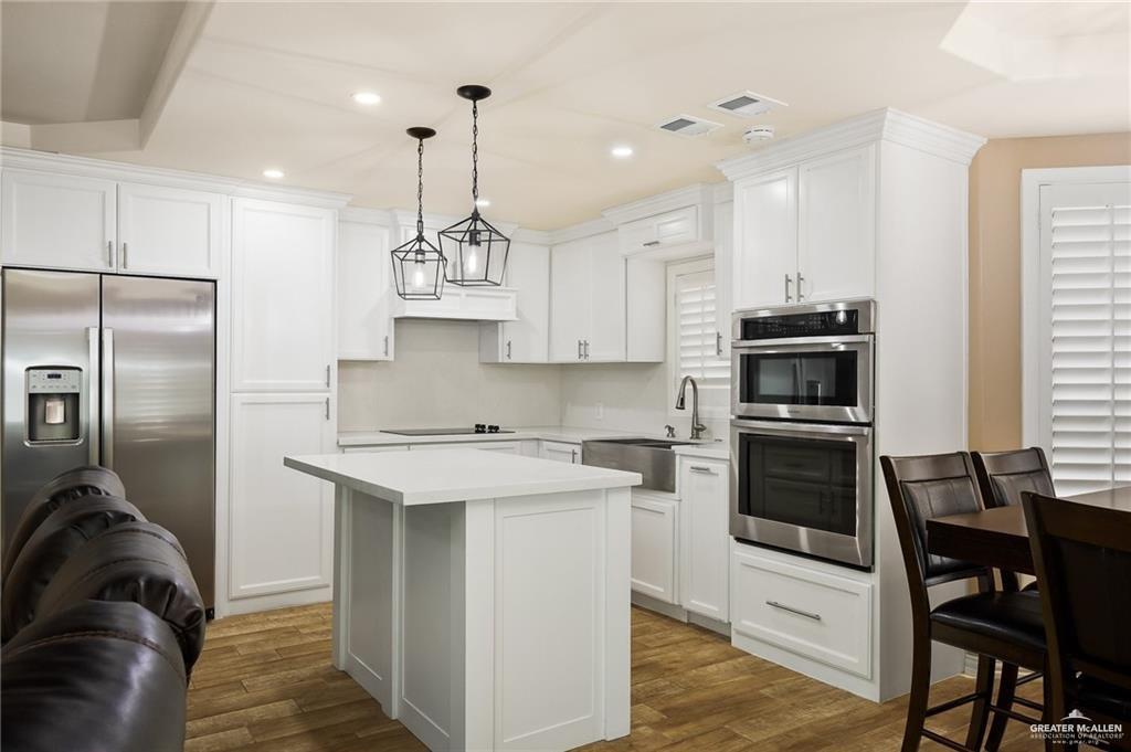 23474 North Val Verde Road Edcouch, TX 78538 - Photo 2 of 12 a kitchen with stainless steel appliances granite countertop a stove a refrigerator a sink a stove with white cabinets