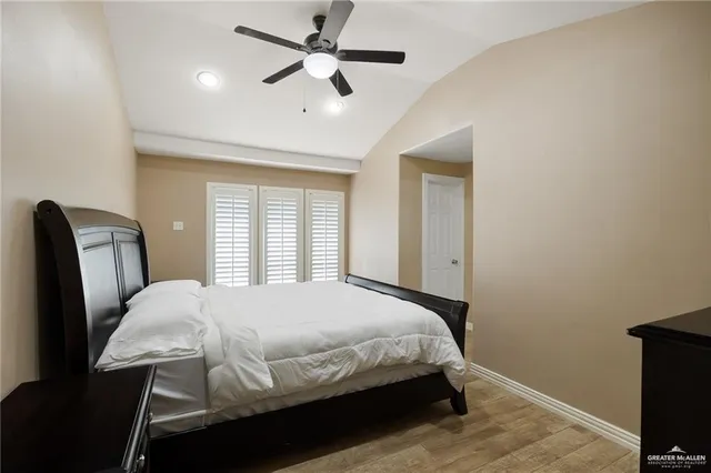 a bedroom with a bed a window and a chandelier