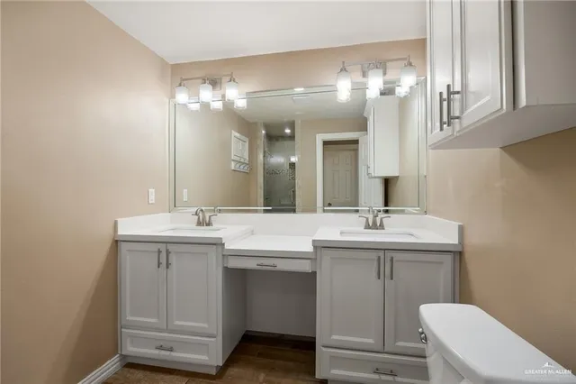a bathroom with a toilet sink and mirror