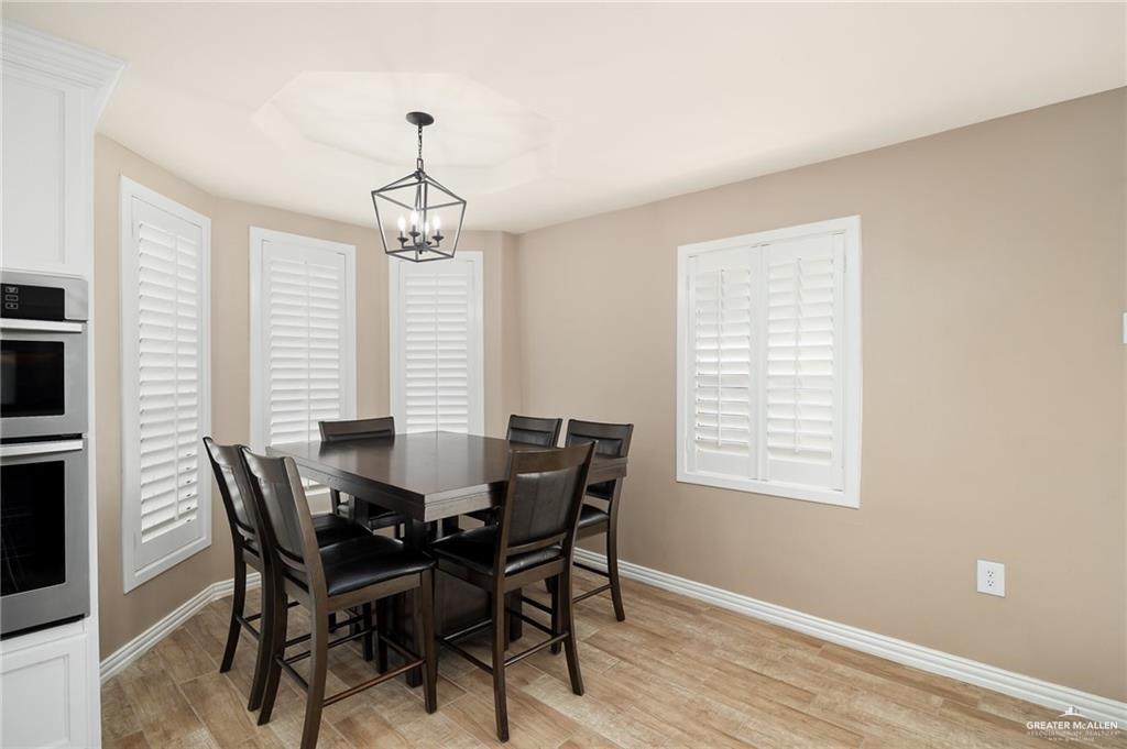 23474 North Val Verde Road Edcouch, TX 78538 - Photo 10 of 12 a view of a dining room with furniture window and wooden floor