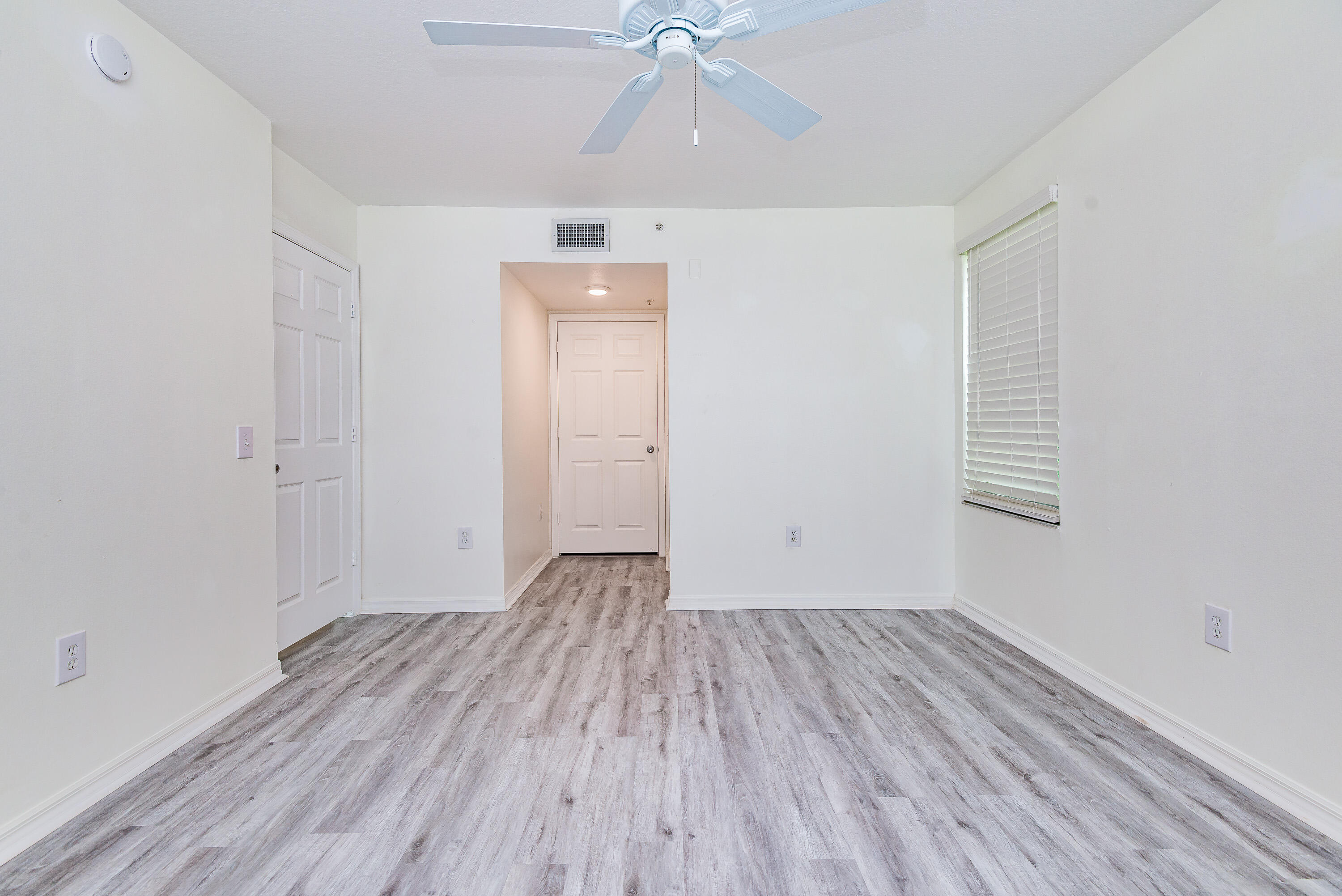 602 Villa Circle Boynton Beach, FL 33435 - Photo 11 of 27 a view of a room with wooden floor and white walls