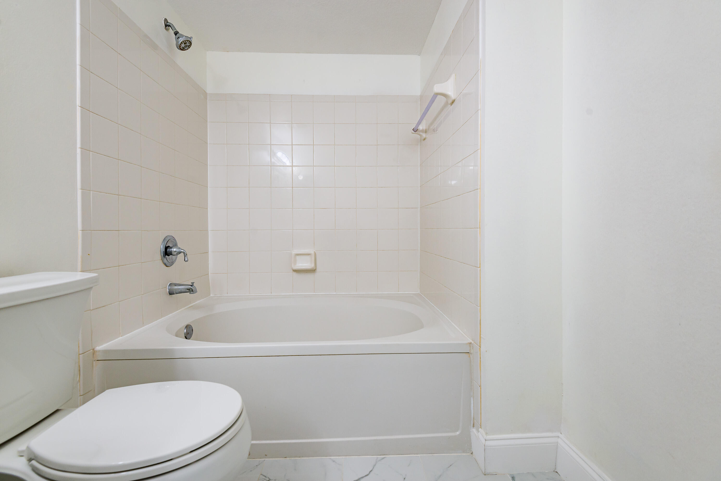 602 Villa Circle Boynton Beach, FL 33435 - Photo 13 of 27 a white bath tub sitting next to a white toilet and sink