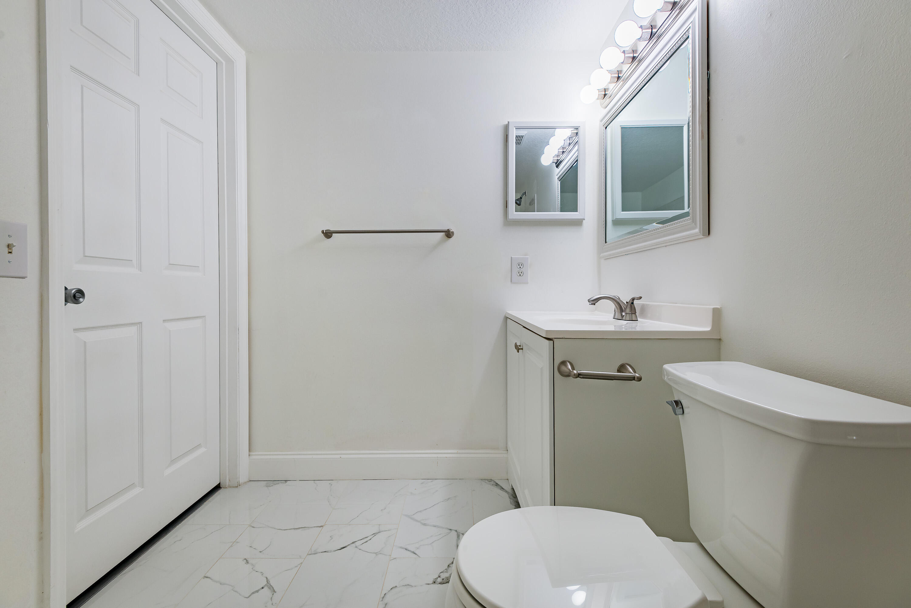 602 Villa Circle Boynton Beach, FL 33435 - Photo 19 of 27 a white toilet sitting next to a bathroom sink