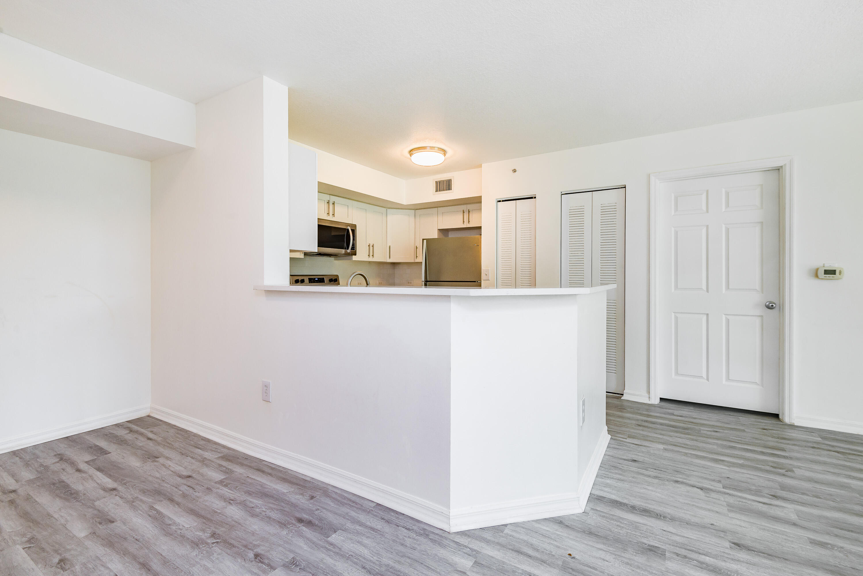 602 Villa Circle Boynton Beach, FL 33435 - Photo 6 of 27 a view of a kitchen with a sink and a refrigerator