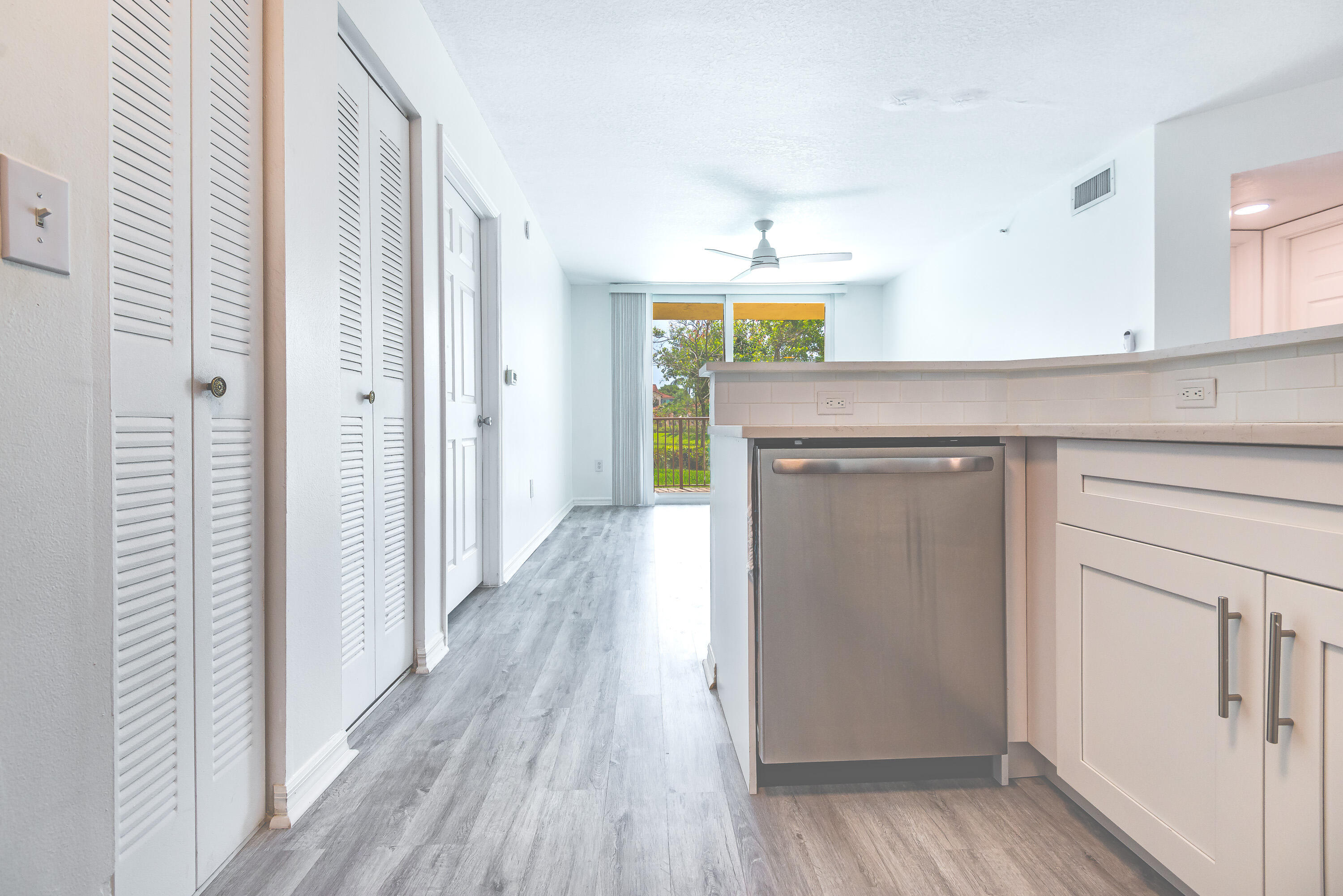 602 Villa Circle Boynton Beach, FL 33435 - Photo 7 of 27 a hallway with wooden floor and staircase