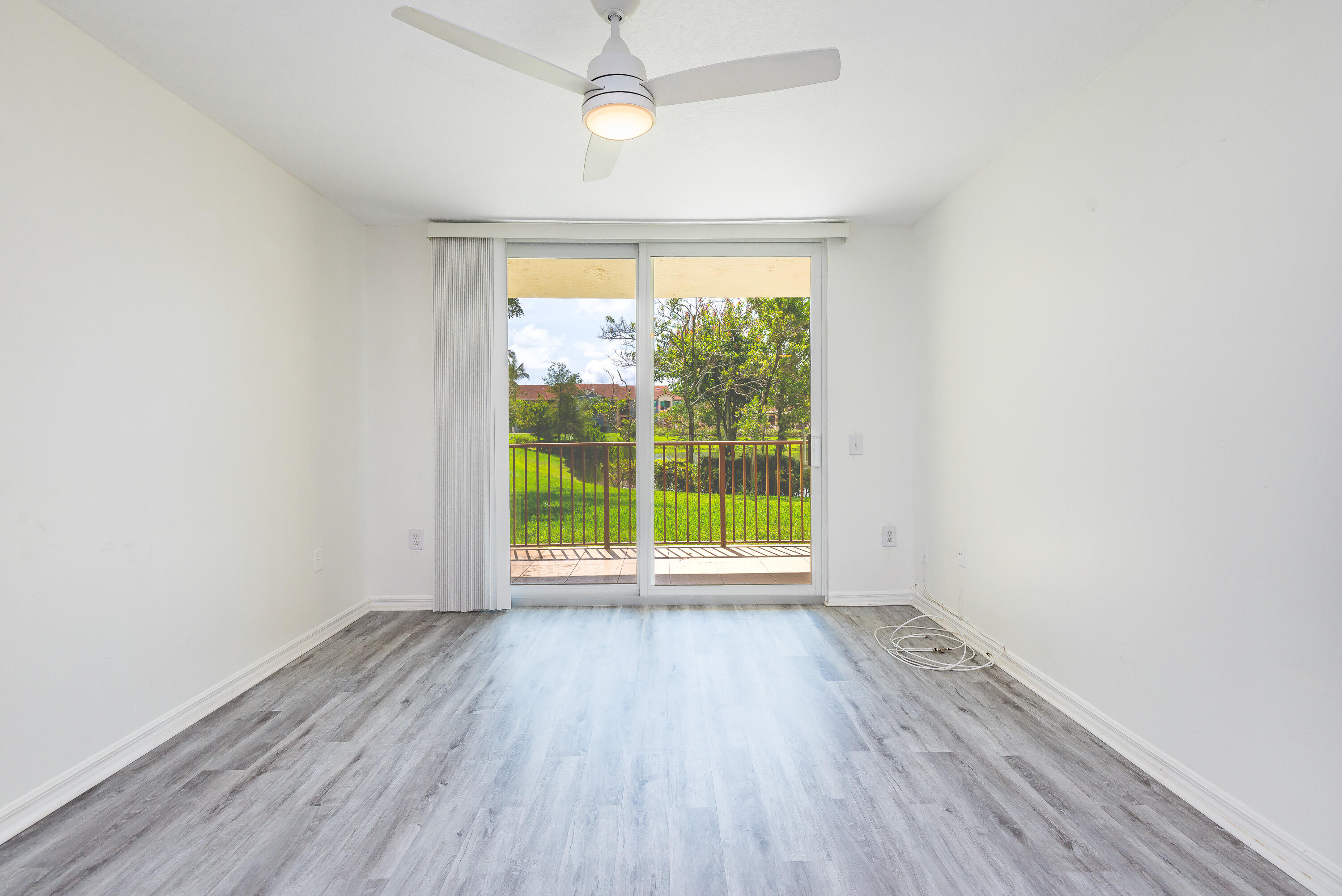 602 Villa Circle Boynton Beach, FL 33435 - Photo 9 of 27 an empty room with wooden floor and windows