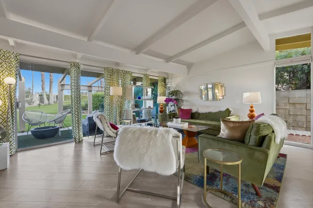 a living room with furniture and a floor to ceiling window
