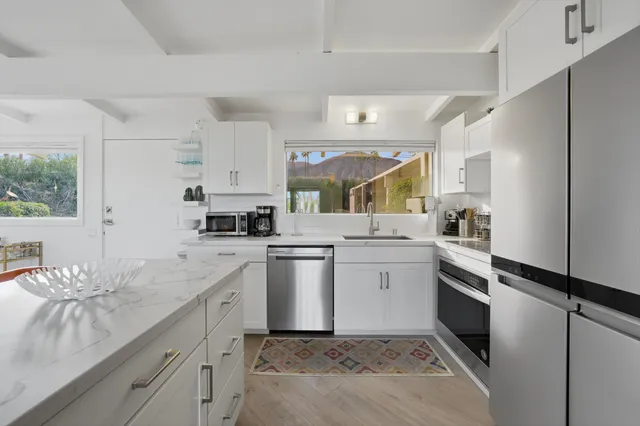 a kitchen with a sink cabinets and stainless steel appliances