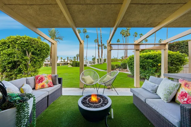 a backyard of a house with table and chairs