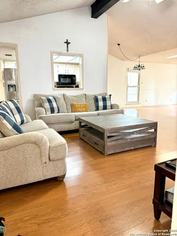 a living room with furniture and large window