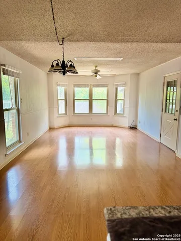 a view of a room with wooden floor