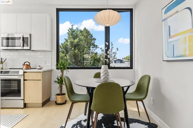 a view of a dining room with furniture and a lamp