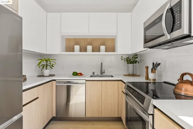 a kitchen with stainless steel appliances a sink a stove and cabinets