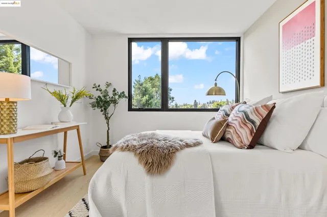 a bedroom with bed and a large window