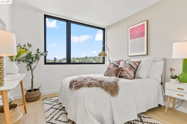 a bedroom with a bed and a large window