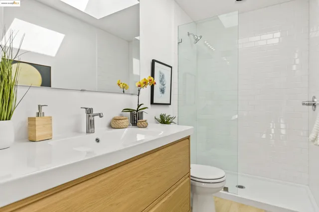 a bathroom with a sink toilet and mirror