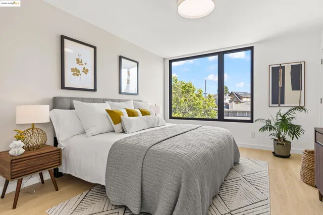 a bedroom with a bed and a large window