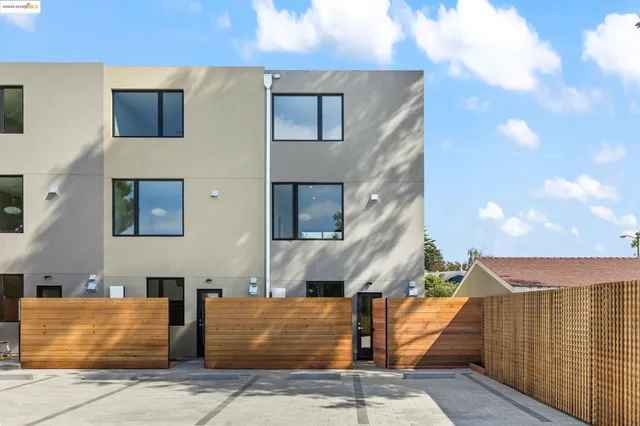 a front view of a house with shower plants
