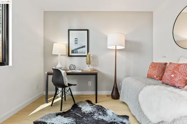 a bedroom with a bed a desk and chair