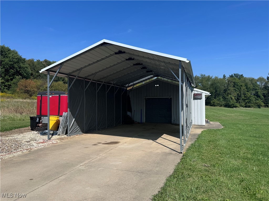 4375 Stimson Road Barberton, OH 44203 - Photo 30 of 30 Garage featuring a lawn and a carport
