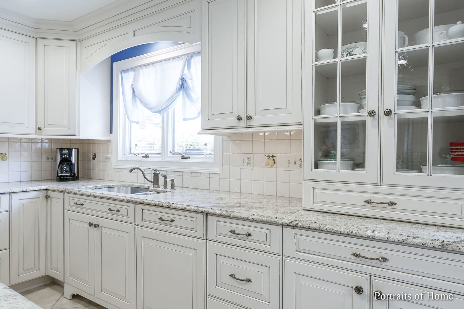 45 Cambridge Drive Oak Brook, IL 60523 - Photo 11 of 41 a kitchen with granite countertop white cabinets and a window