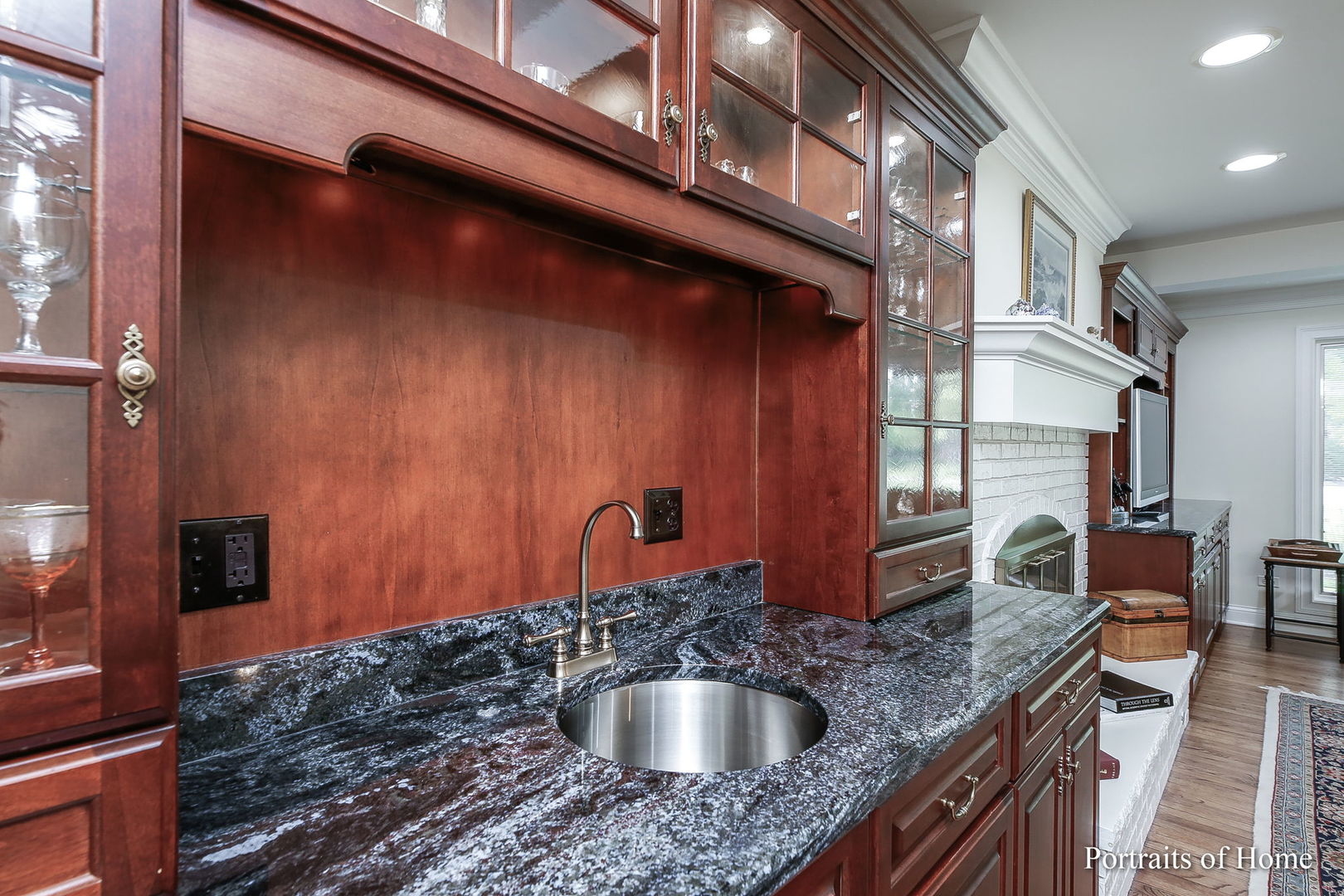 45 Cambridge Drive Oak Brook, IL 60523 - Photo 15 of 41 a kitchen with a granite countertop sink and cabinets
