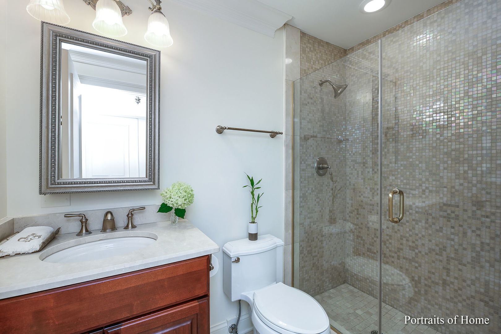 45 Cambridge Drive Oak Brook, IL 60523 - Photo 17 of 41 a bathroom with a granite countertop sink toilet a mirror and shower