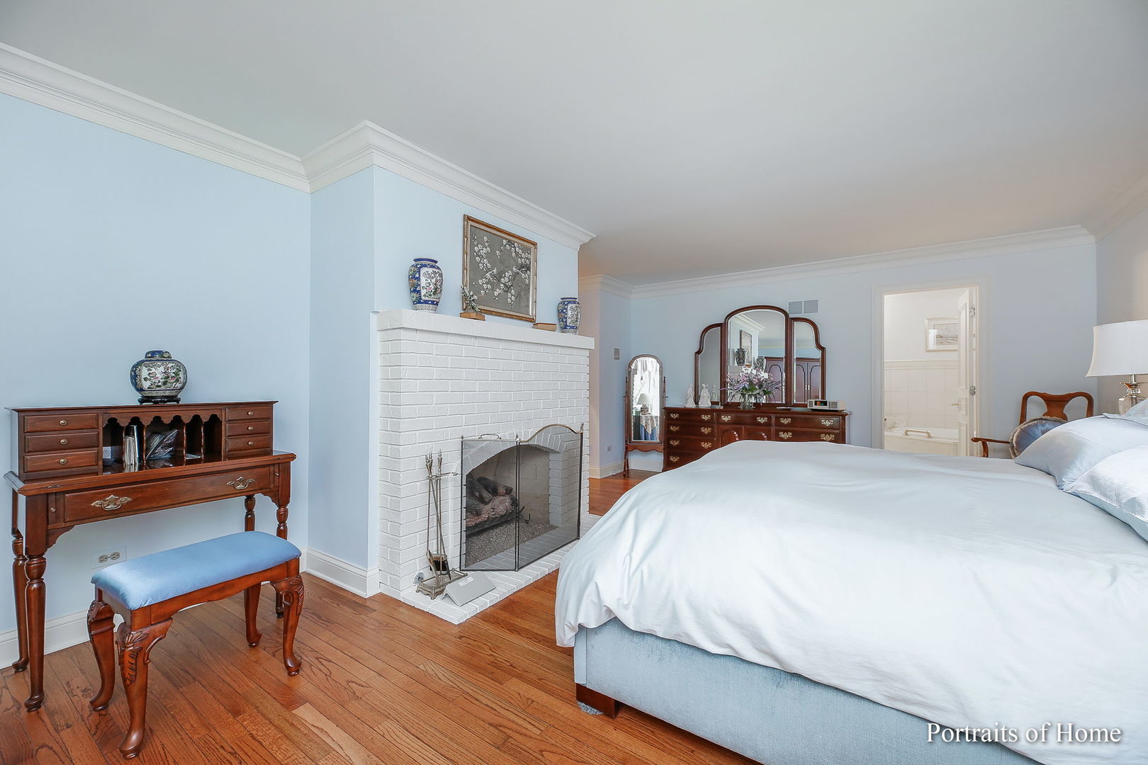 45 Cambridge Drive Oak Brook, IL 60523 - Photo 20 of 41 a bedroom with a bed and a fireplace