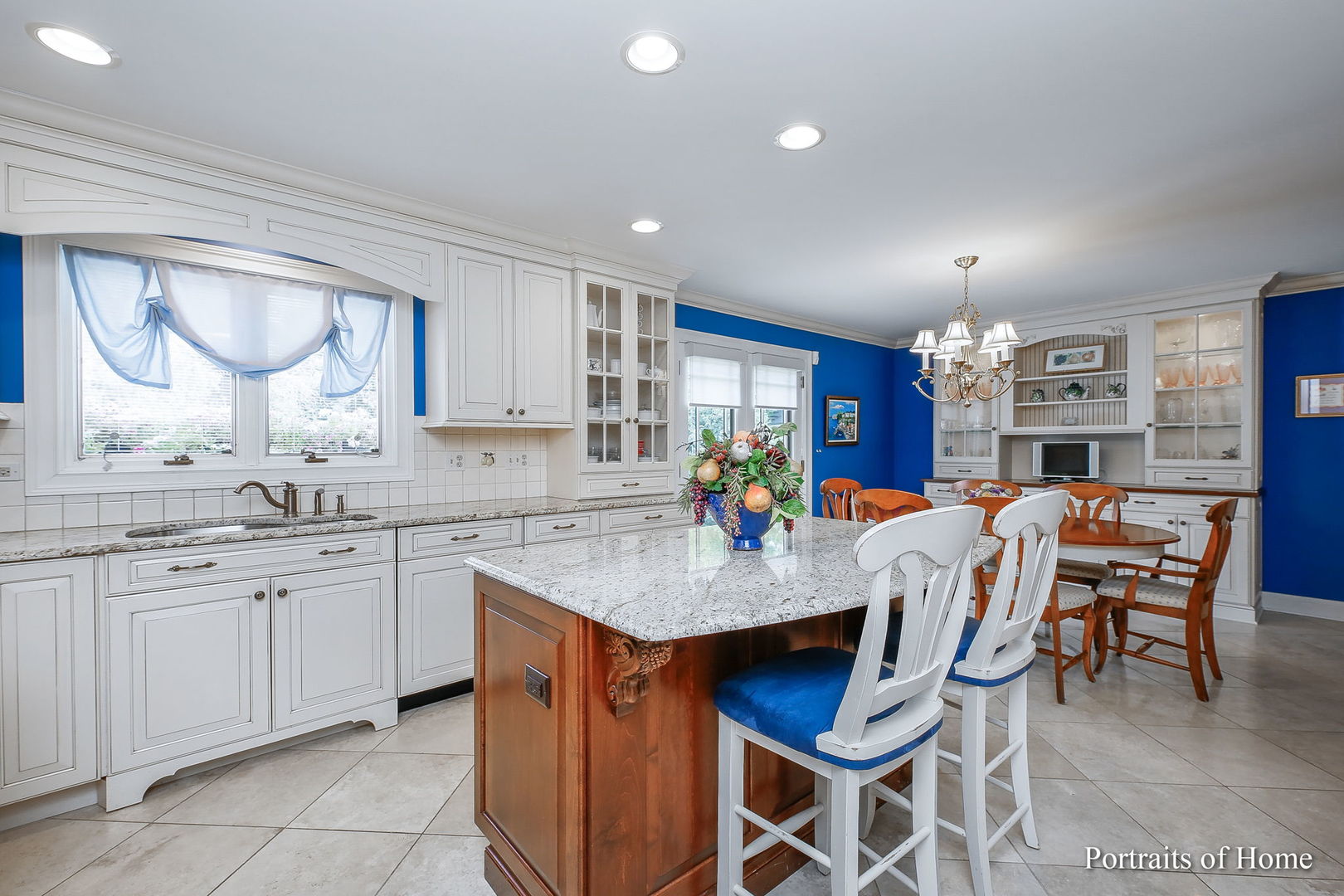 45 Cambridge Drive Oak Brook, IL 60523 - Photo 9 of 41 a room with granite countertop stainless steel appliances a sink table and chairs