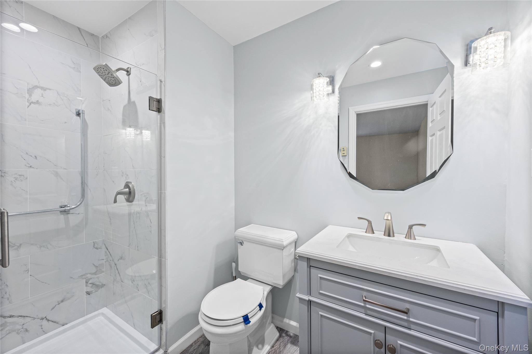 220 Belfast Lane Ridge, NY 11961 - Photo 35 of 44 a bathroom with a sink toilet and shower
